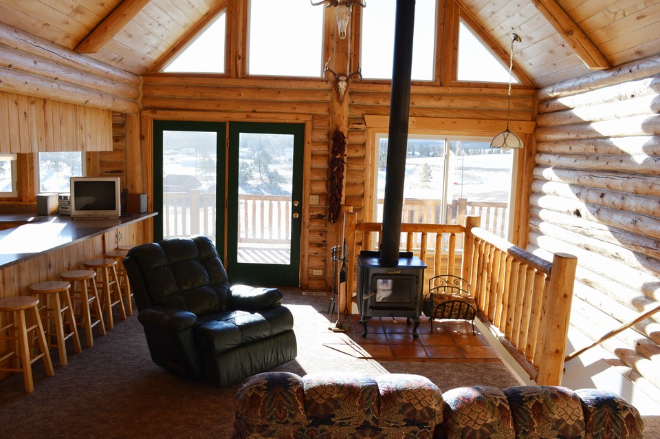 living room living room features cozy, free-standing wood stove for enjoying snow days.
