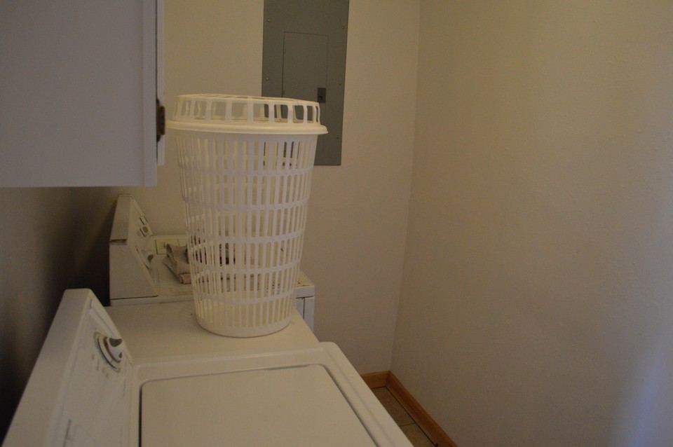 laundry room laundry room has space for work and cabinet for added storage.